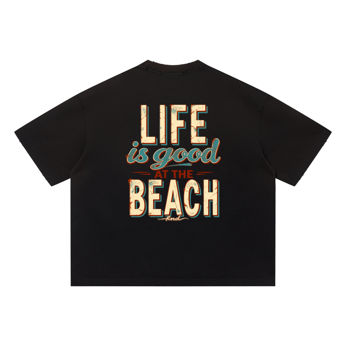 At the Beach Sun-Fade Tee, Black — back print: worn cream, teal and rust lettering reading “Life is good at the beach” with a small knd signature