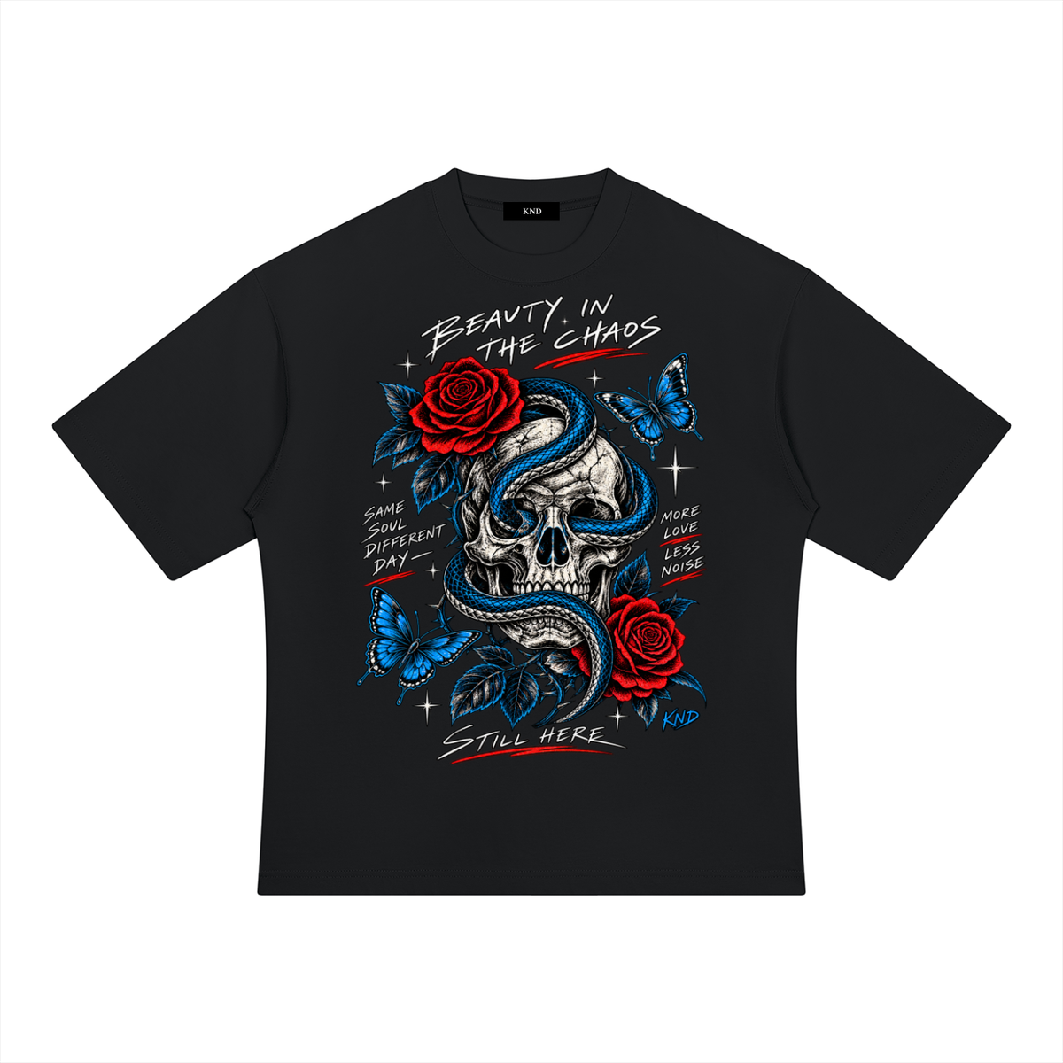 Beauty In The Chaos Heavyweight Tee, Black — front print, skull wrapped in a blue snake with red roses and blue butterflies, with the words Beauty In The Chaos, Same Soul Different Day, More Love Less Noise and Still Here