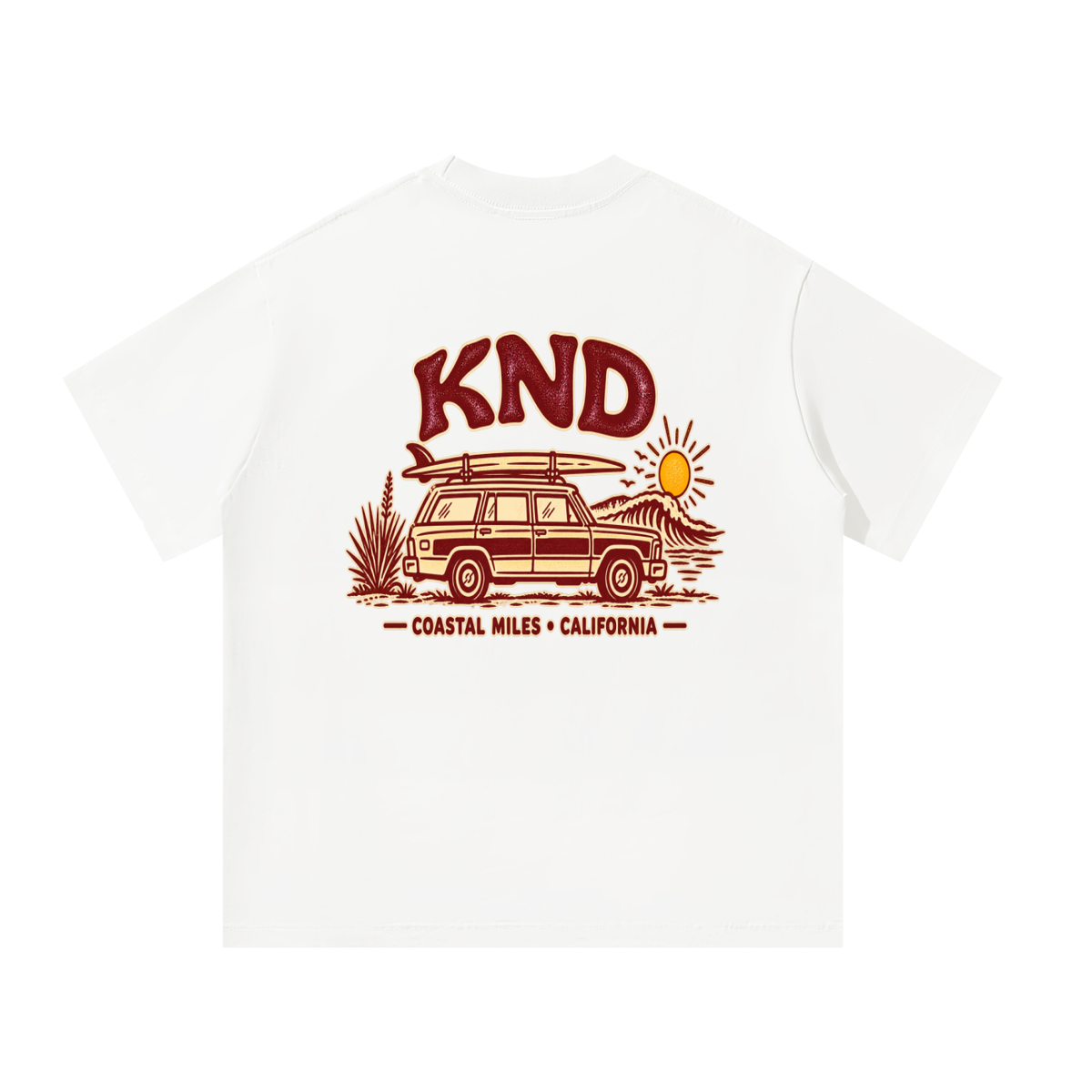 Coastal Miles Tee, White — back print: a woodie station wagon with a surfboard on the roof beside a curling wave, under burgundy KND lettering and “Coastal Miles · California”