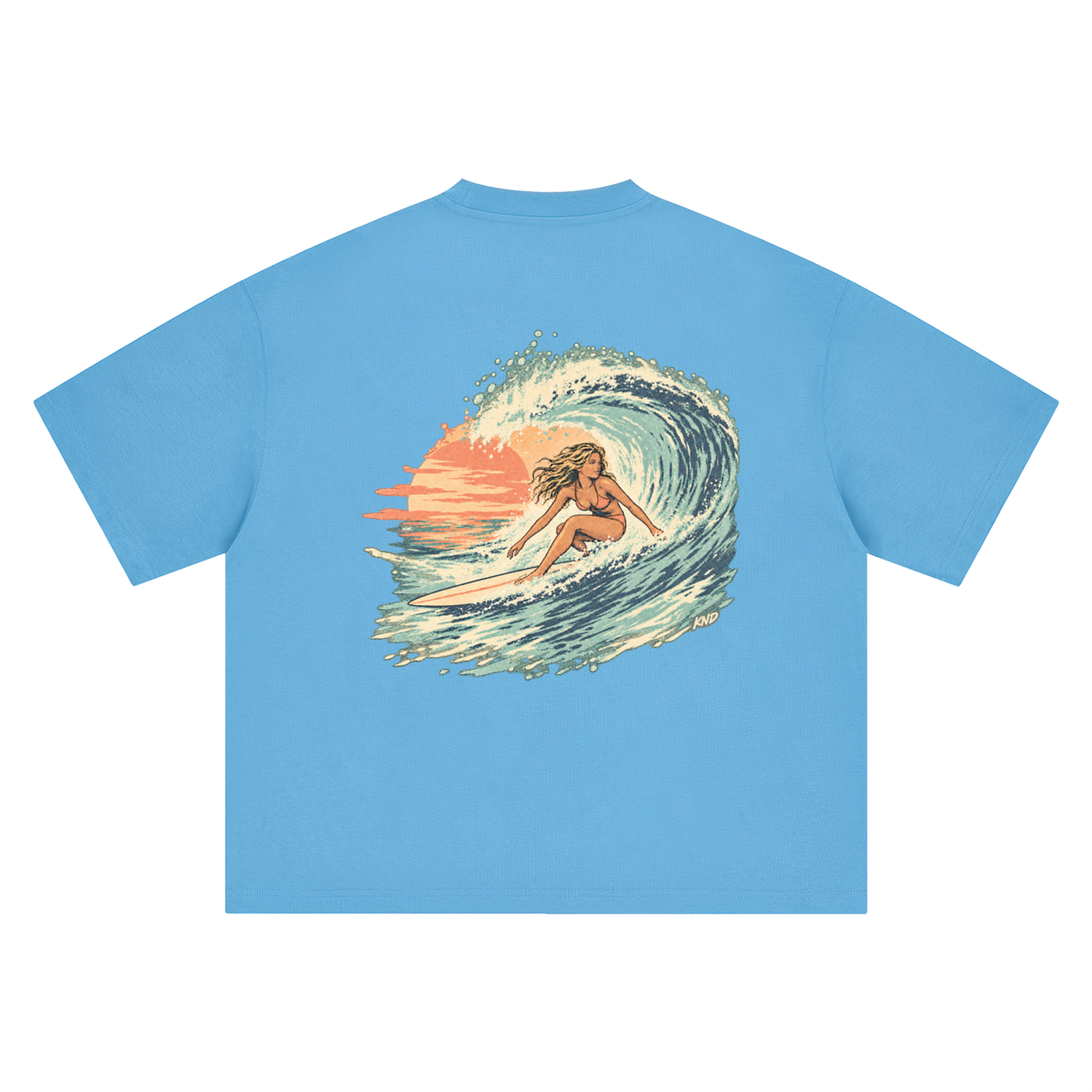 Sunset Curl Tee, Sky Blue — back print, surfer girl riding a curling wave against a setting sun