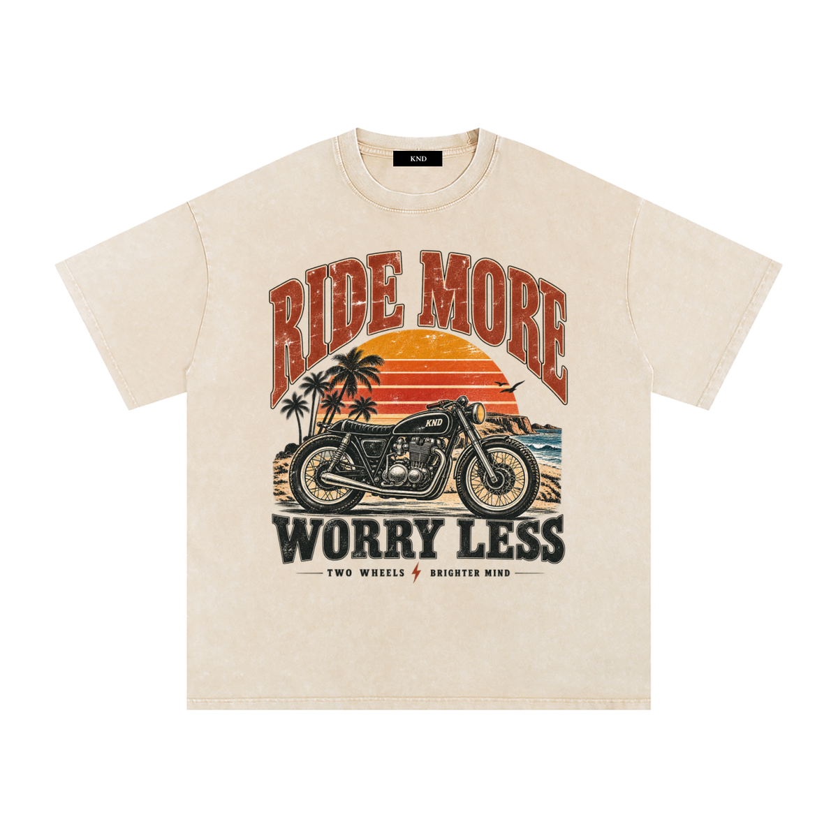Ride More Worry Less Washed Tee, Apricot — front print, café-racer motorcycle and coastal sunset graphic
