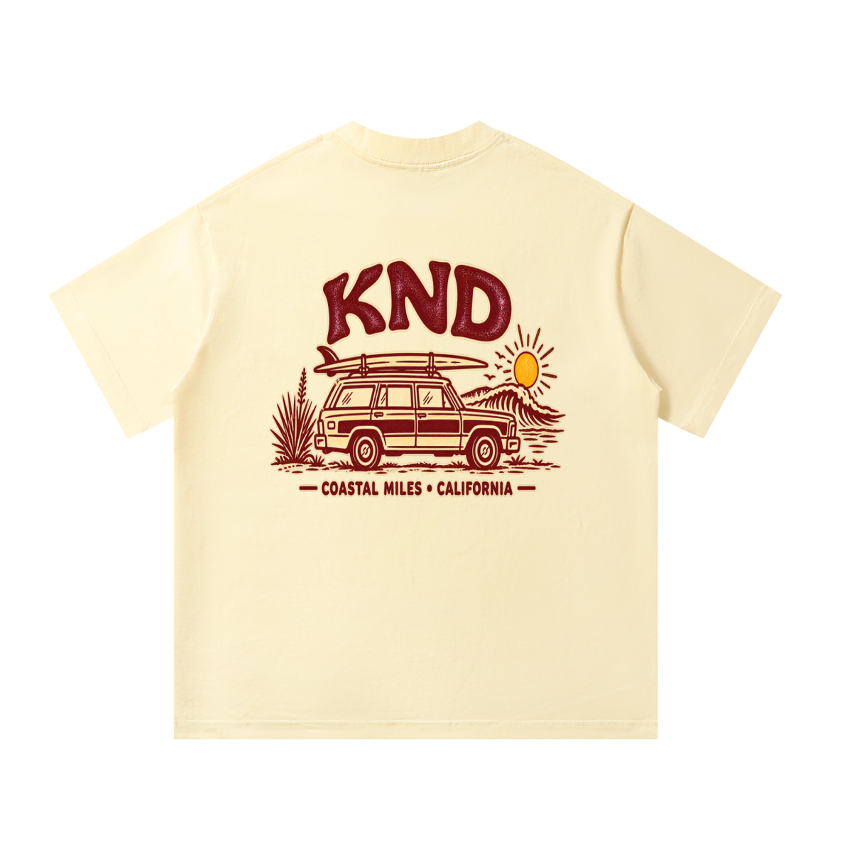 Coastal Miles Tee, Apricot — back print: a woodie station wagon with a surfboard on the roof beside a curling wave, under burgundy KND lettering and “Coastal Miles · California”