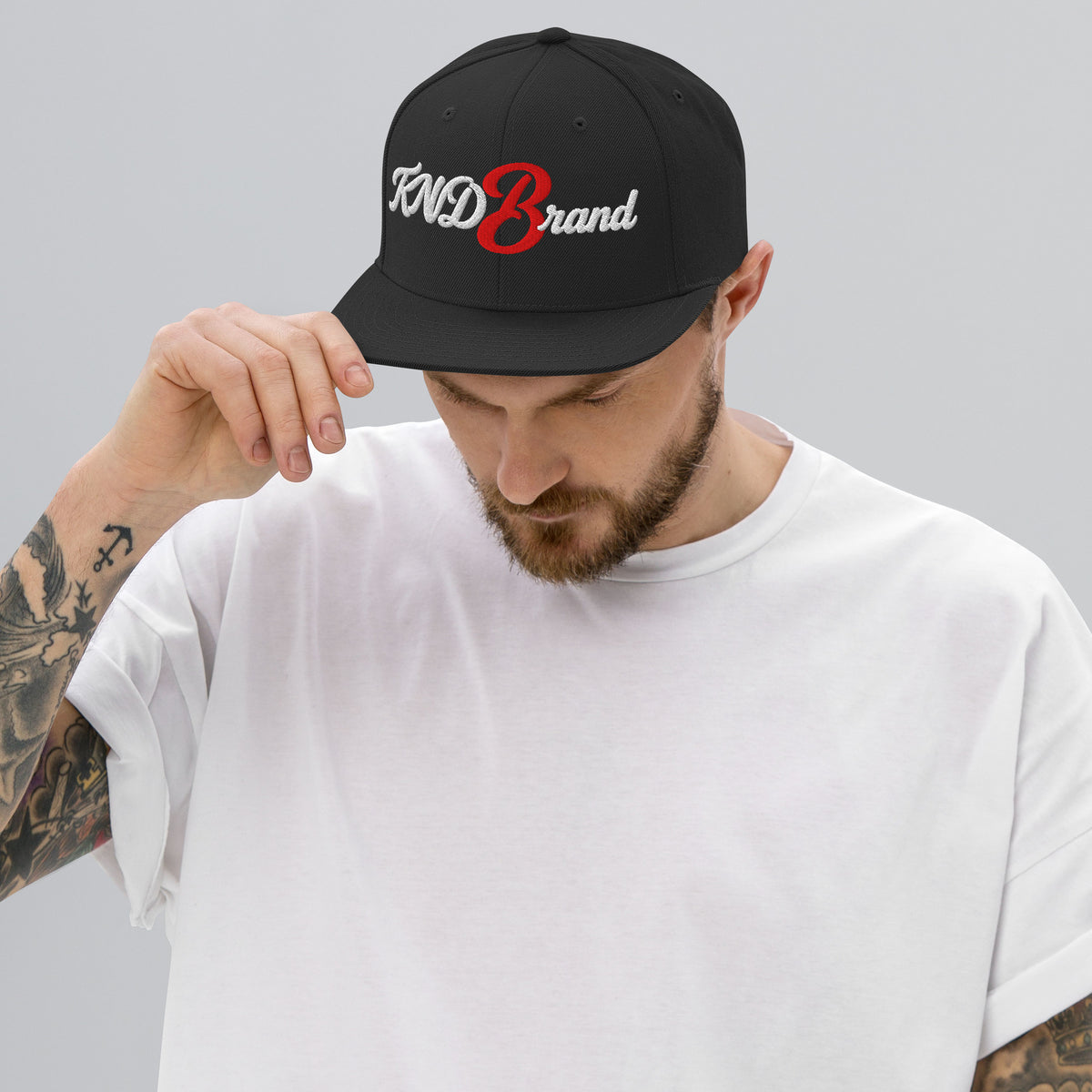 KND Script Snapback in black — white KND Brand script with a red B embroidered front, front view