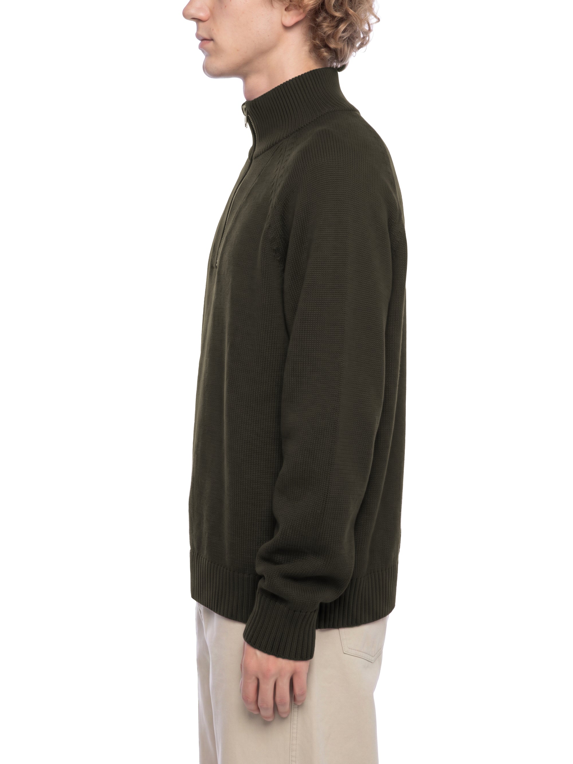 Male model wearing the KND Brand quarter-zip cotton sweater, three-quarter view