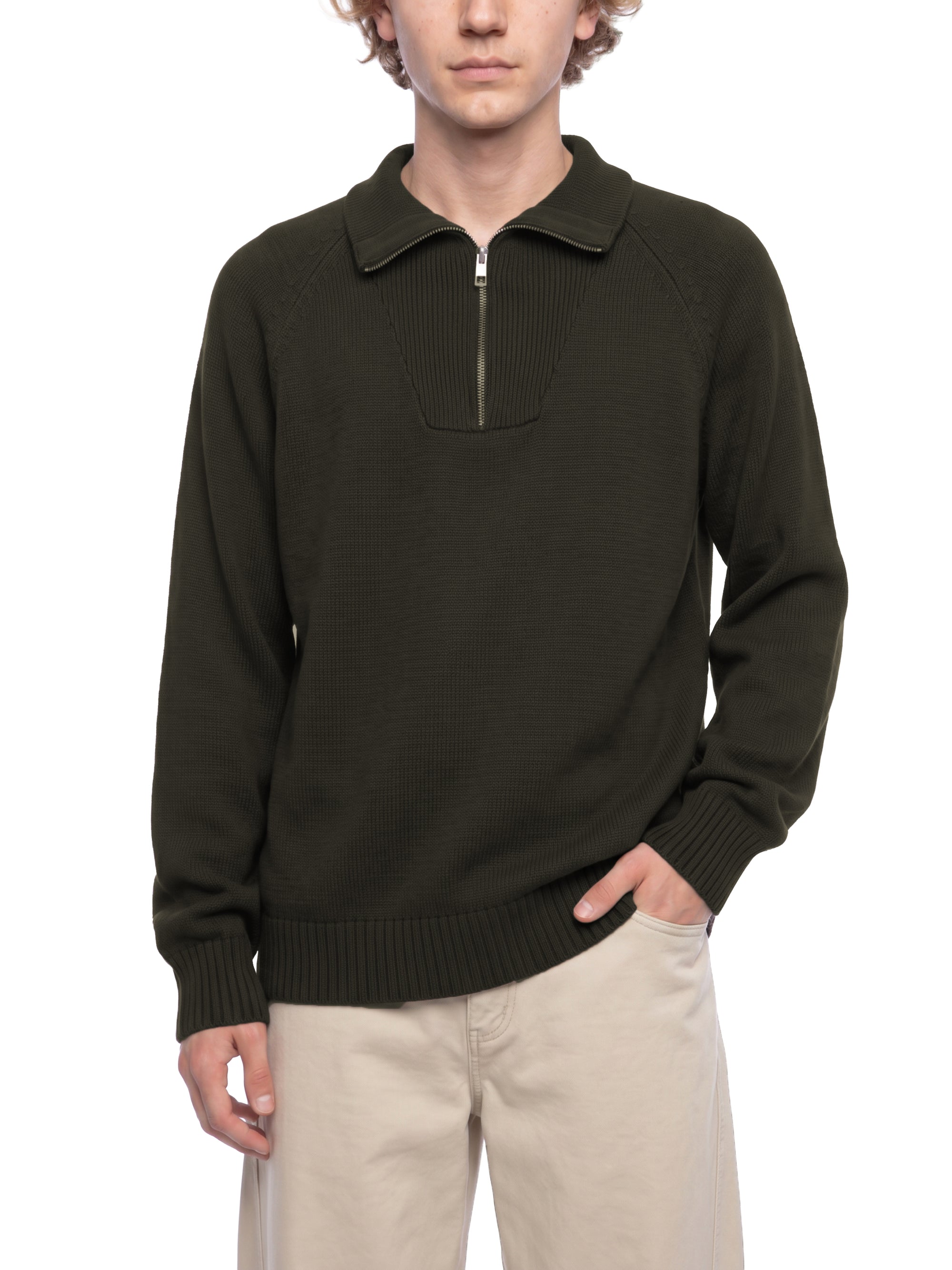 Male model wearing the KND Brand quarter-zip sweater, side profile showing raglan sleeve