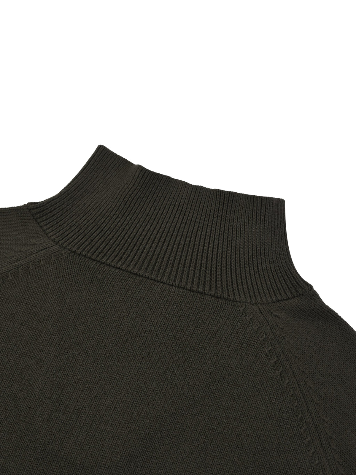 Detail of the raglan seam construction on the KND Brand quarter-zip sweater