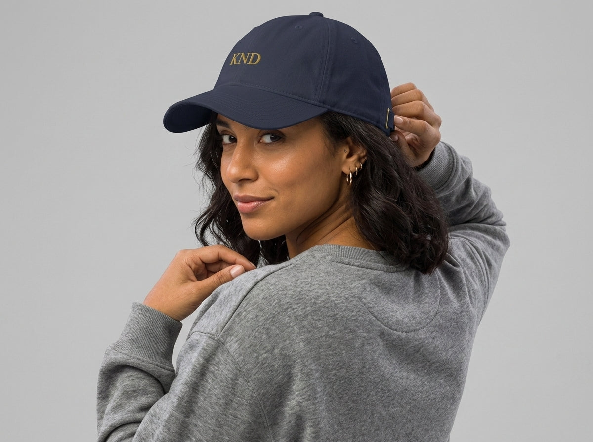 KND Wordmark Cap in navy — gold KND wordmark embroidered centre-front, pre-curved visor